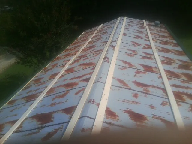 Rusted metal roof panels with new wood purlins before replacement — Storm Damage Roof Repair in Westerville by Roofing Brothers